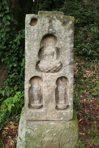 写真：3体の仏像が彫られている笠塔婆