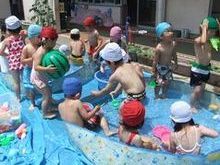 写真：ビニールプールで遊ぶ年少児
